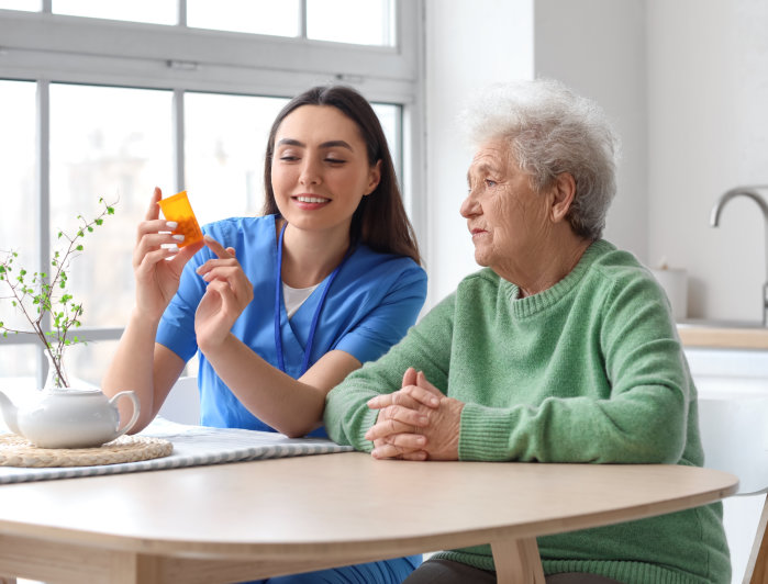 caregiver explain the medication to her patient