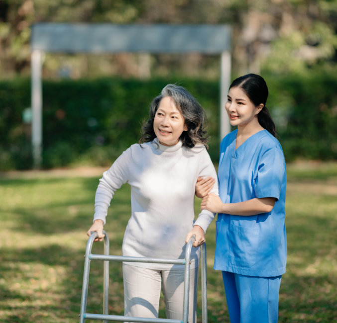 caregiver and elderly woman outside