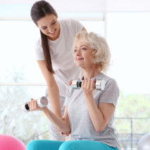 caregiver assist her patient in doing exercise