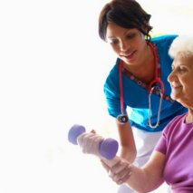 caregiver helping elderly exercise